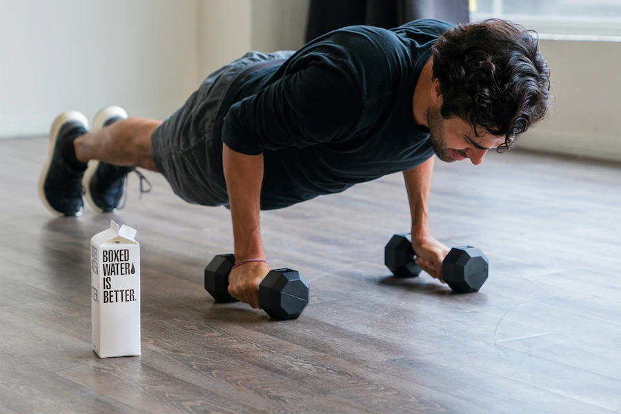 A client doing dumbbell push-ups at home